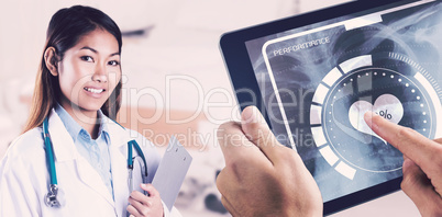 Composite image of asian doctor holding clipboard