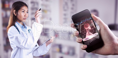 Composite image of asian doctor pointing with pen