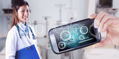 Composite image of asian doctor holding blue binder