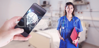 Composite image of asian nurse with stethoscope looking at the c