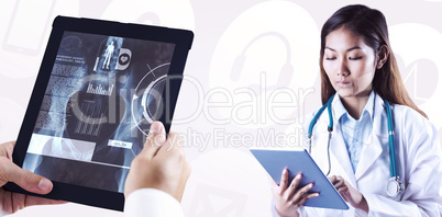 Composite image of asian doctor using tablet