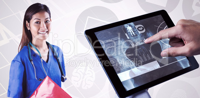 Composite image of asian nurse with stethoscope looking at the c