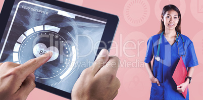 Composite image of asian nurse with stethoscope looking at the c