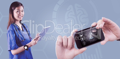 Composite image of asian nurse using tablet
