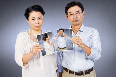 Composite image of asian couple holding a photo