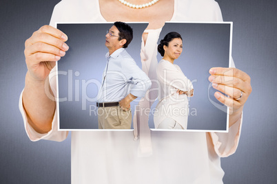 Composite image of woman holding a torn photo