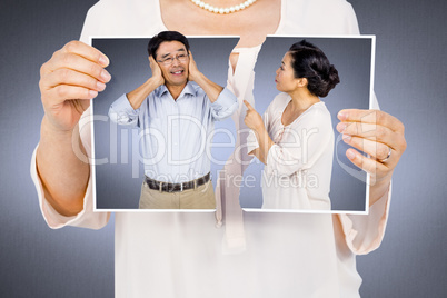 Composite image of woman holding a torn photo