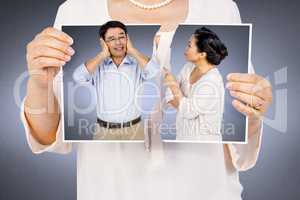Composite image of woman holding a torn photo