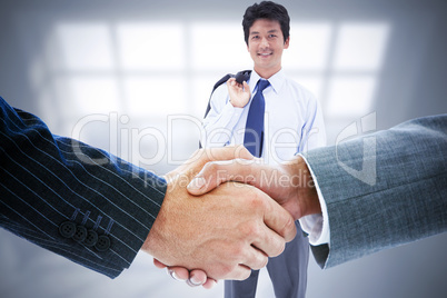 Composite image of business people shaking hands