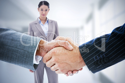 Composite image of business people shaking hands