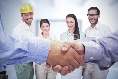 Composite image of two men shaking hands