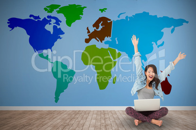 Composite image of asian woman cheering at camera with laptop si