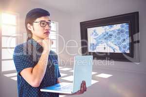 Composite image of thoughtful hipster using his laptop