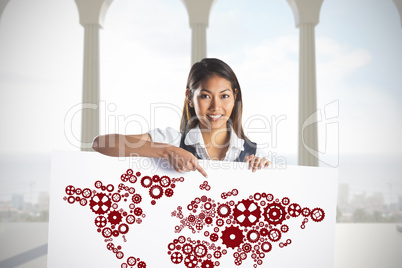 Composite image of smiling businesswoman pointing a white poster