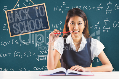 Composite image of smiling businesswoman reading