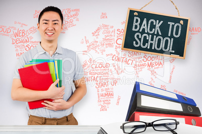 Composite image of smiling man holding files