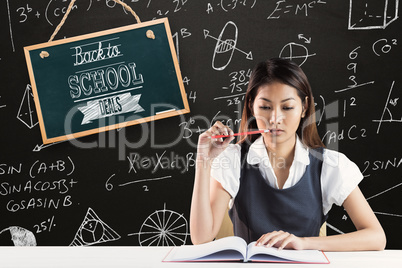 Composite image of thoughtful businesswoman reading