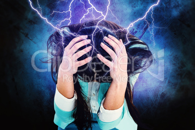 Composite image of worried businesswoman holding her head