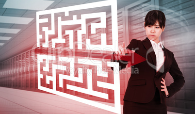 Composite image of focused businesswoman pointing