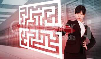 Composite image of focused businesswoman pointing