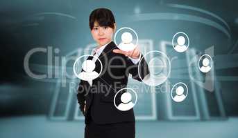 Composite image of focused businesswoman pointing