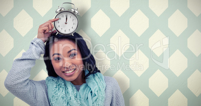 Composite image of asian woman pointing her paper crown