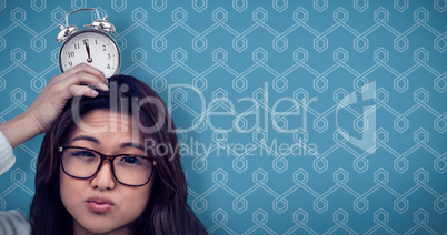 Composite image of asian woman with paper crown posing for the c