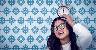 Composite image of asian woman with paper crown posing for the c