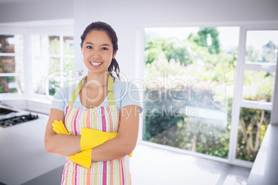 Composite image of smiling woman wearing rubber gloves and apron