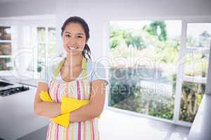 Composite image of smiling woman wearing rubber gloves and apron