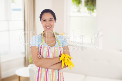 Composite image of woman holding gloves and wearing an apron