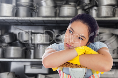 Composite image of troubled woman leaning on a mop