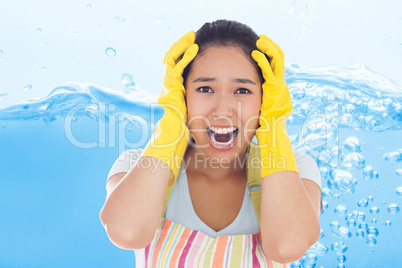 Composite image of distressed woman wearing apron and rubber glo