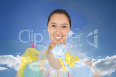 Composite image of happy woman wiping in front of her