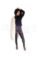 African American woman standing in fur coat.