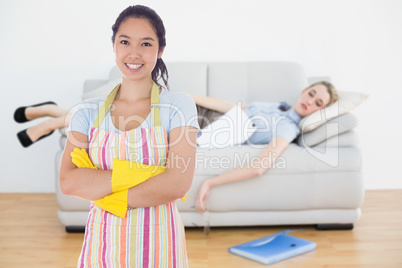 Composite image of smiling woman wearing rubber gloves and apron