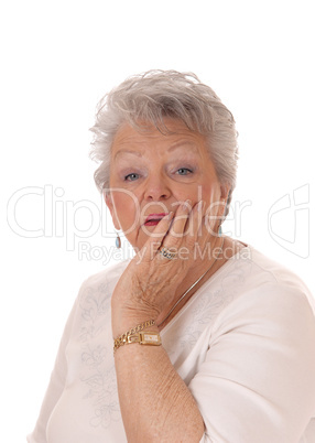 Senior woman holding face in her hand.