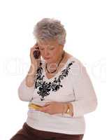 Senior woman buying over phone.