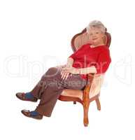 Senior lady resting in armchair.