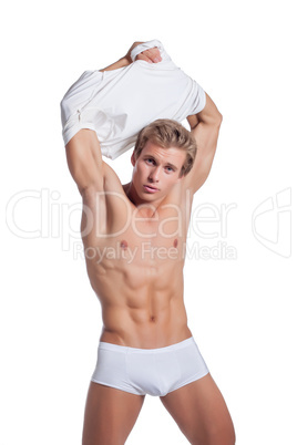 Image of sexy young man takes off his t-shirt