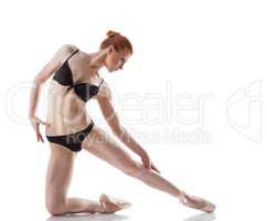 Graceful ballerina isolated on white backdrop