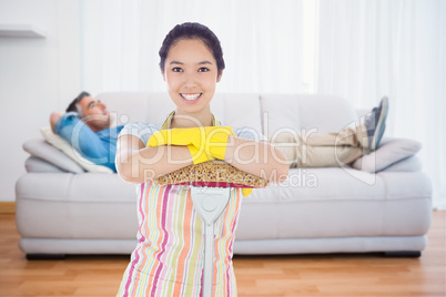 Composite image of smiling woman leaning on mop