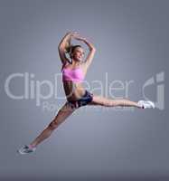 Image of happy young female athlete posing in jump