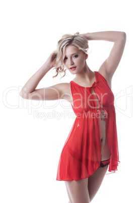 Shot of smiling blond girl in red erotic negligee