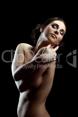 Portrait of slim topless girl hugging herself