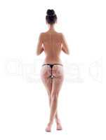 Slim topless girl posing in thong, back to camera