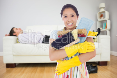 Composite image of woman nearly dropping her cleaning tools