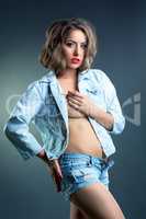 Beddable young woman posing in jeans clothes