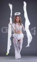 Smiling young female dancer posing as angel