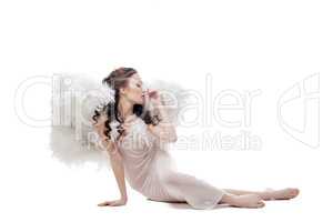 Innocent cute girl posing in angel costume